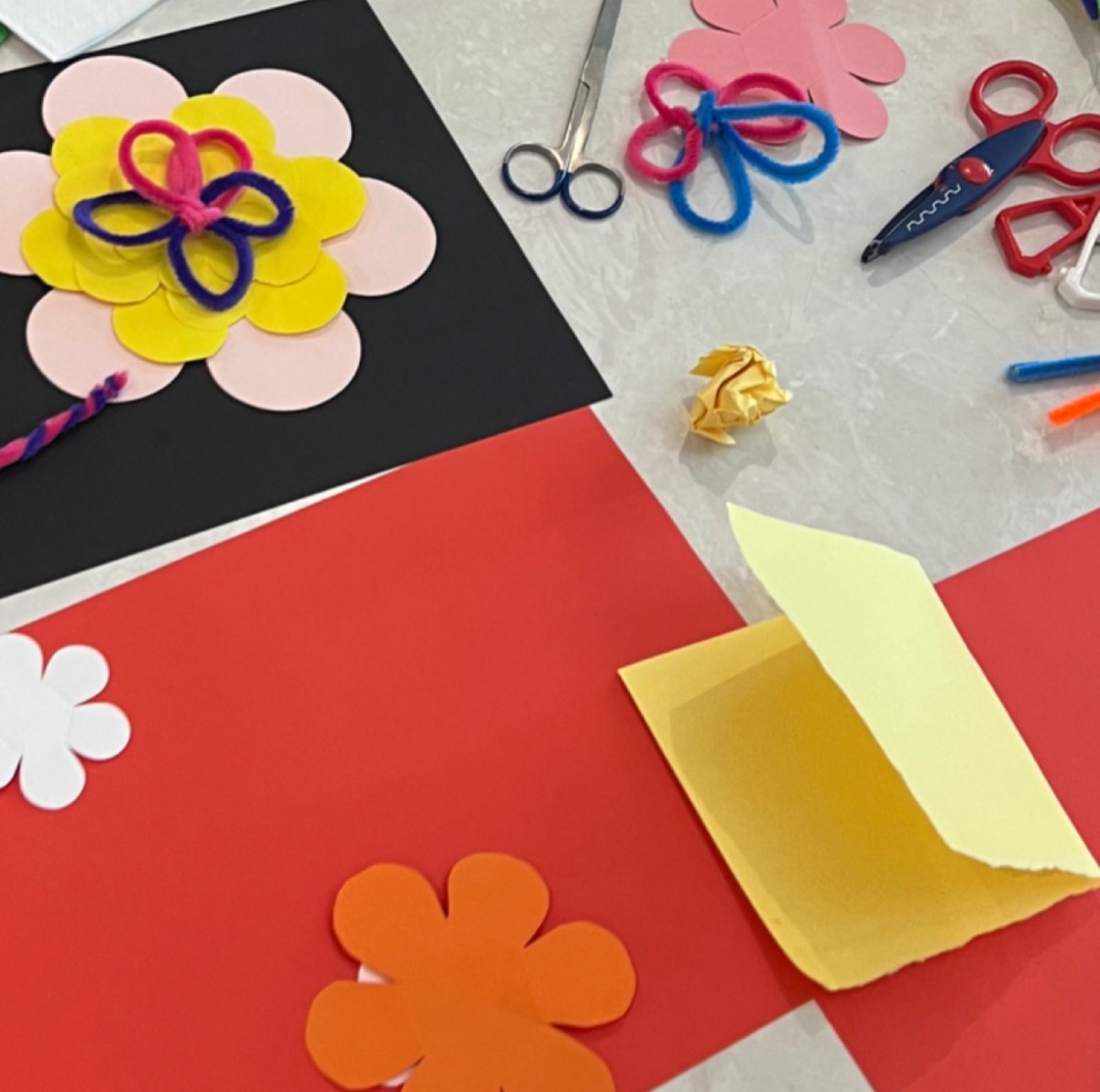 Paper flowers, pipe cleaners and scissors from a craft session